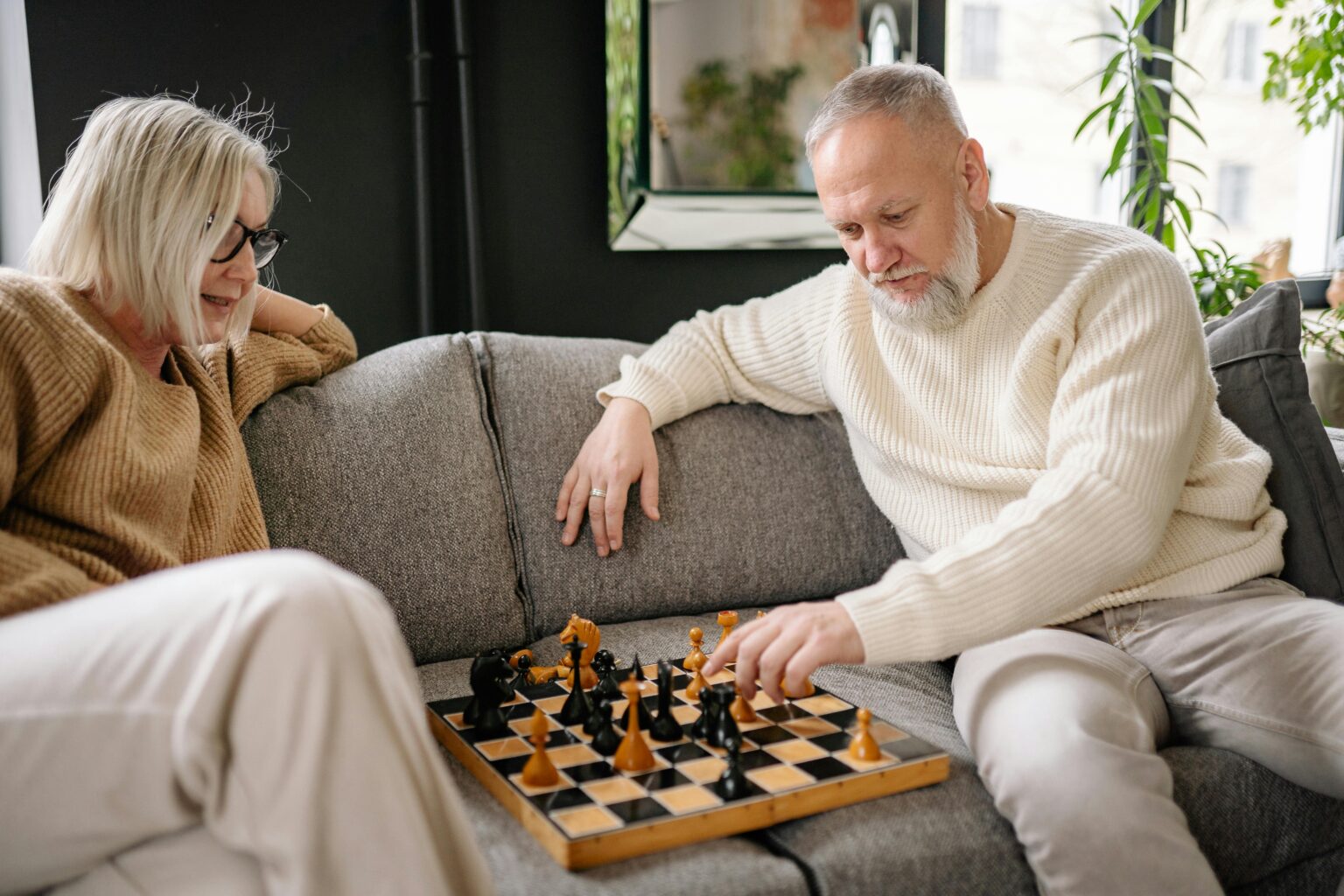 elderly couple playing chess